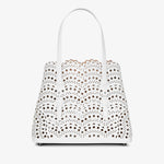 White handbag with floral cut-out design on a white background