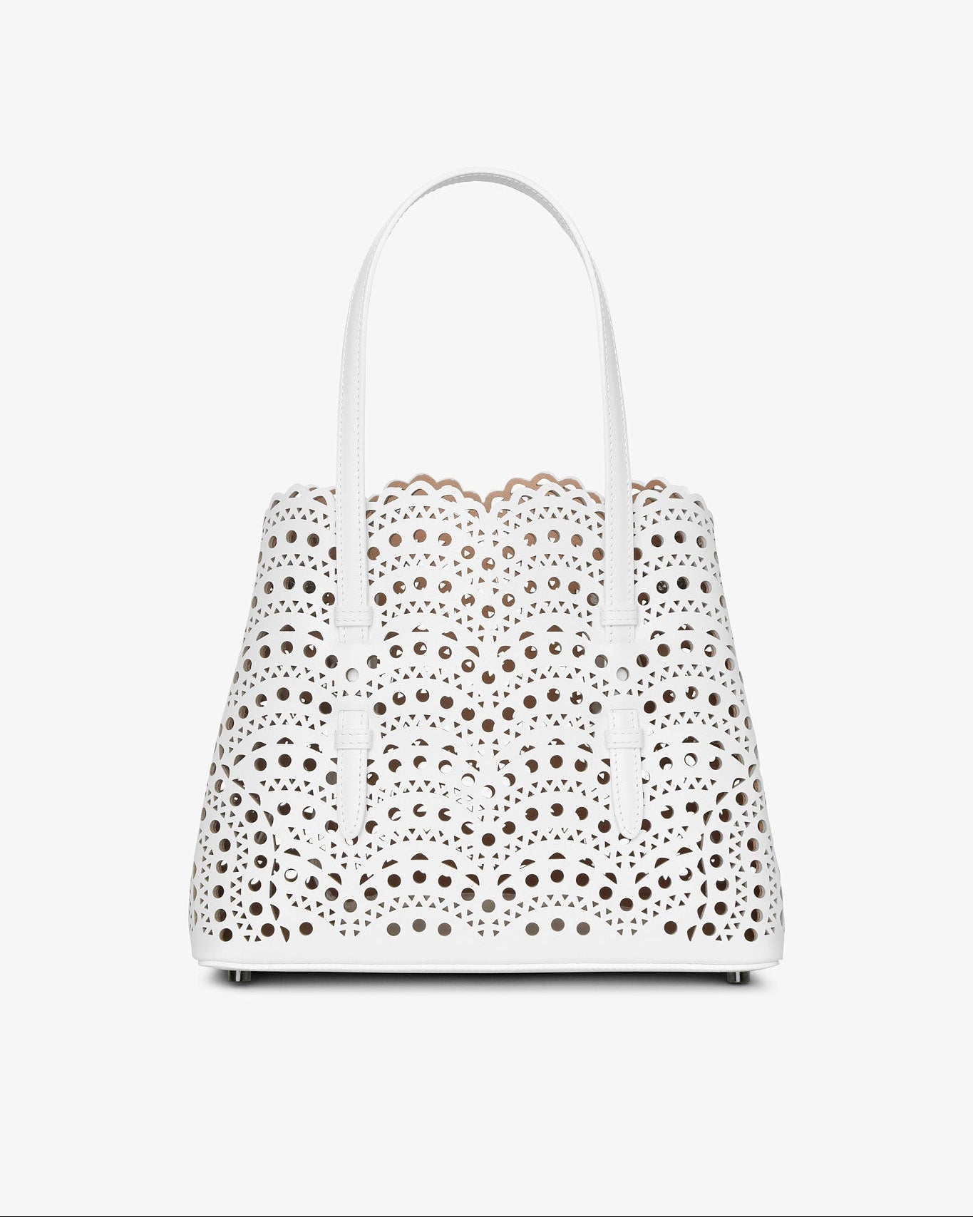 White handbag with floral cut-out design on a white background