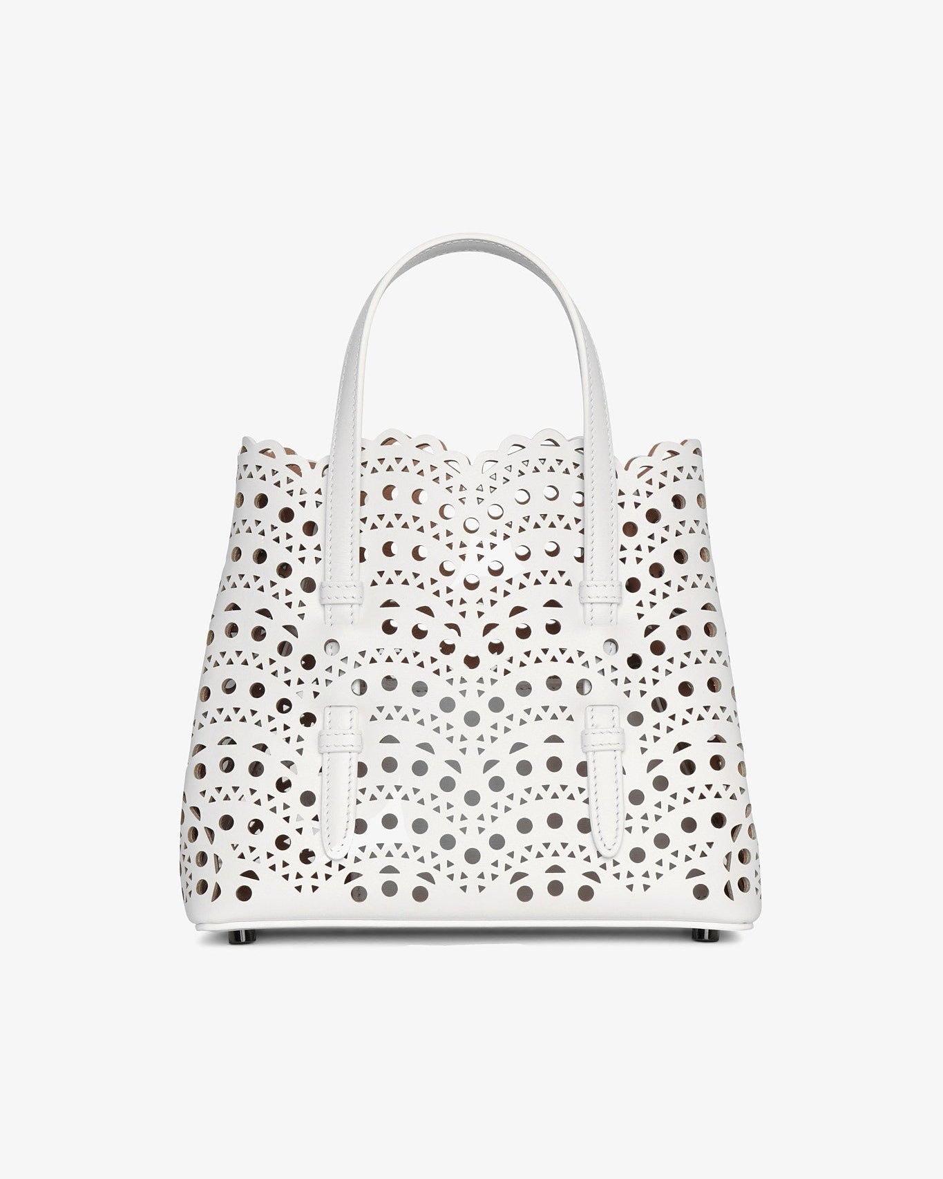 White handbag with black polka dot pattern on a white background