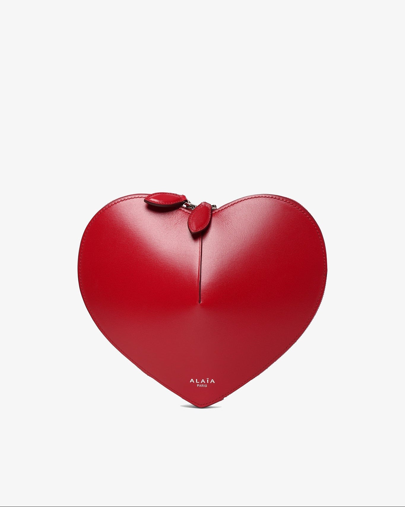 Red heart-shaped handbag with a bow on a light gray background