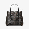 Black perforated handbag on a white background