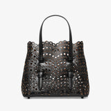 Black perforated handbag on a white background