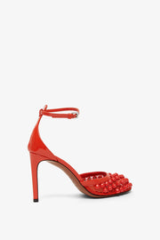 Red studded fishnet pumps