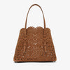 Brown perforated handbag on a white background