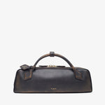 Black leather handbag with gold accents on a light gray background