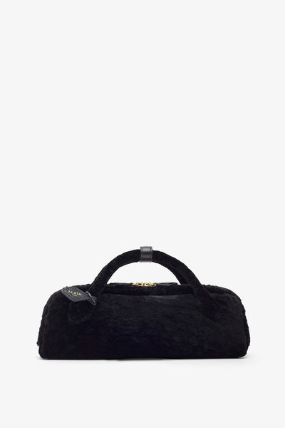 Le Teckel black shearling clutch