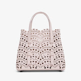 Handbag with a polka dot pattern on a white background
