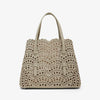 Beige handbag with decorative studs on a white background