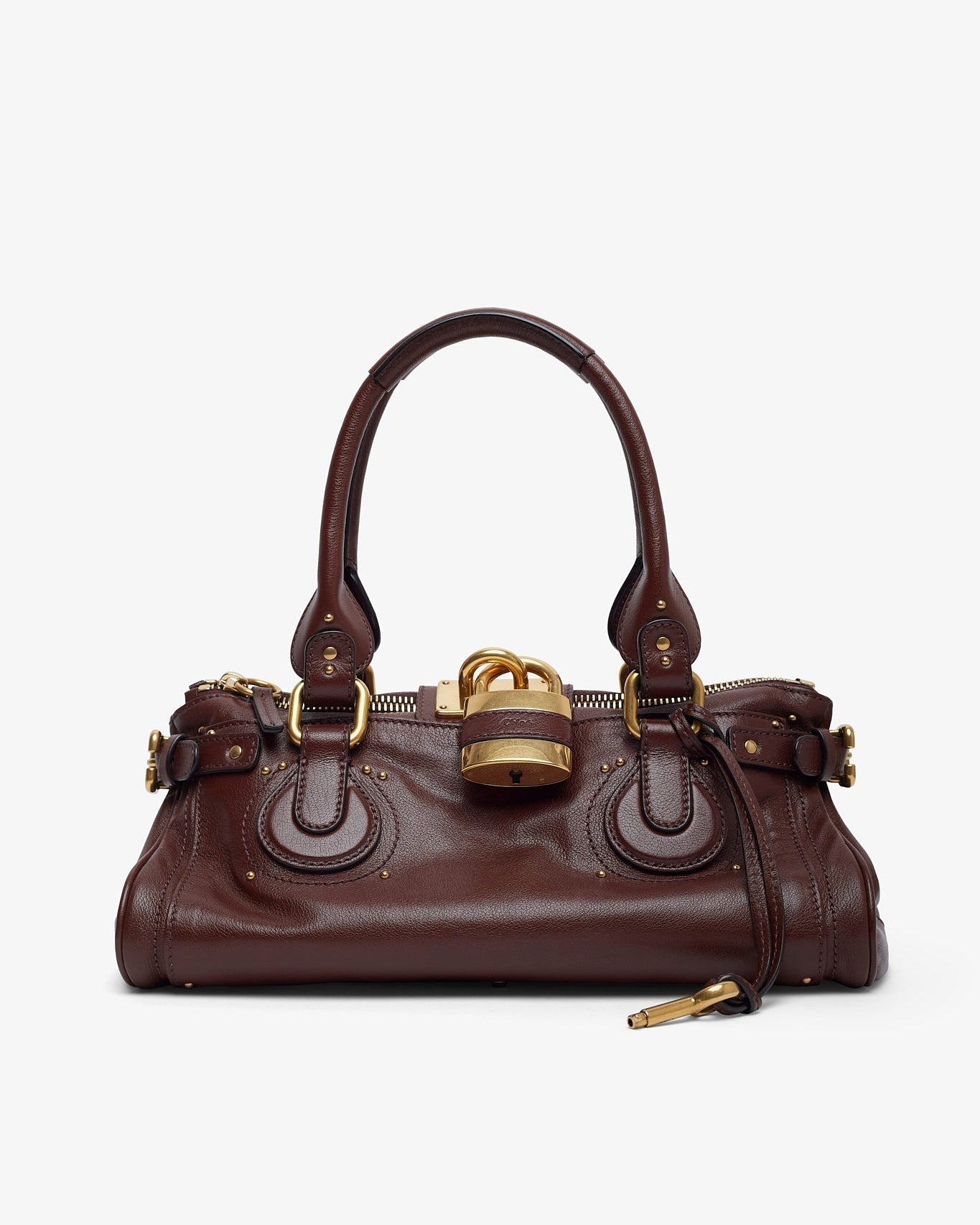 Brown leather handbag with gold accents on a white background