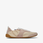 Beige slip-on shoe with a white sole on a light beige background