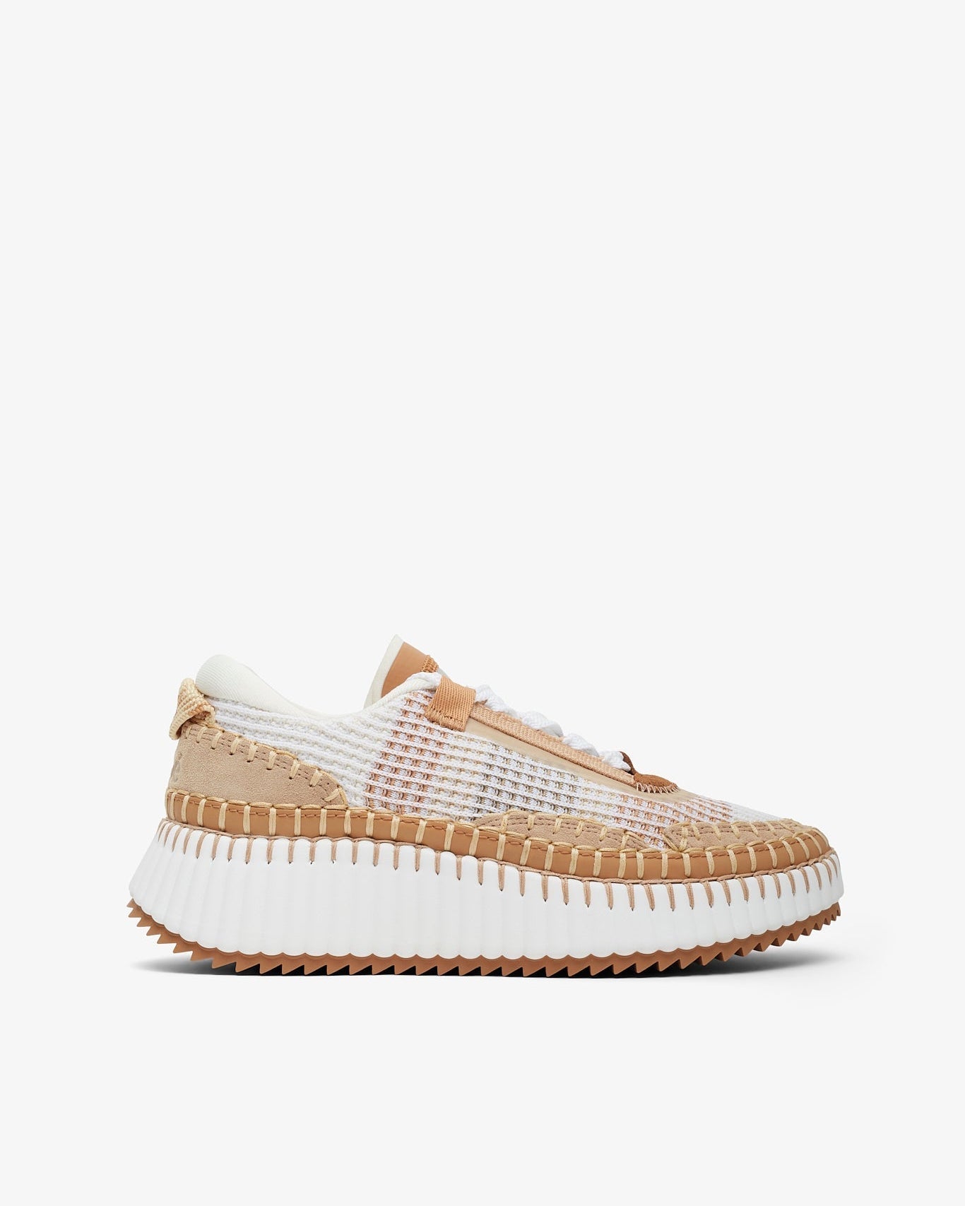 Sneaker with white sole and beige mesh upper on a white background