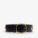 Black leather belt with gold buckle on a white background