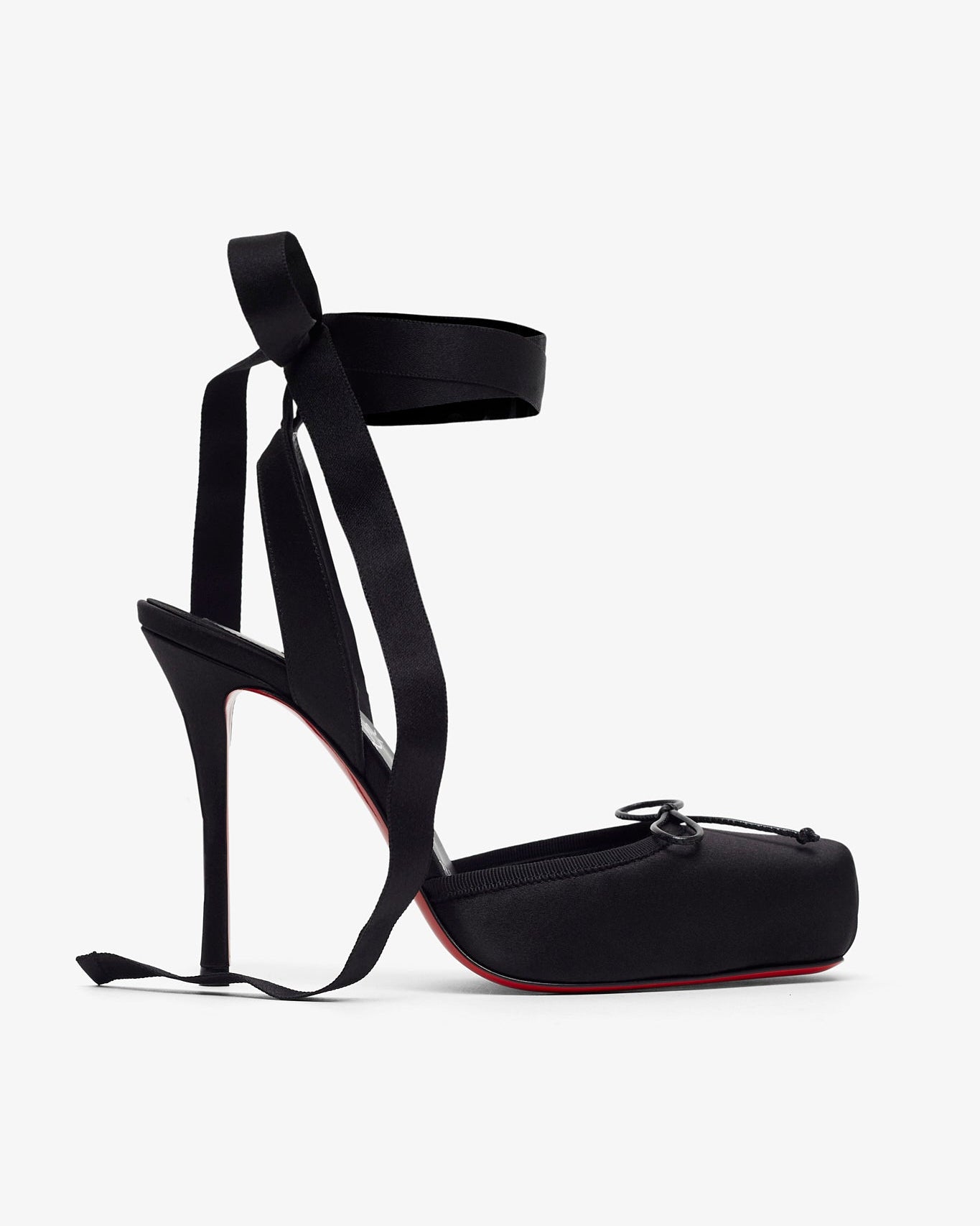 Black high-heeled shoes with ribbon straps on a white background