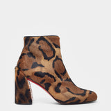 Leopard print ankle boot with a block heel on a white background