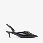 Black slingback shoe with decorative bow on a white background