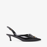 Black slingback shoe with decorative bow on a white background