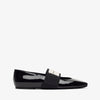 Black patent leather loafer on a white background