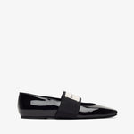 Black patent leather loafer on a white background