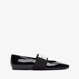 Black patent leather loafer on a white background