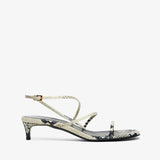 High-heeled sandal with a strap on a white background