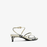 High-heeled sandal with thin straps on a white background