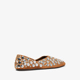 Brown flat shoe with decorative silver studs on a white background
