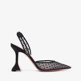 Black high-heeled shoe with a slingback design on a white background