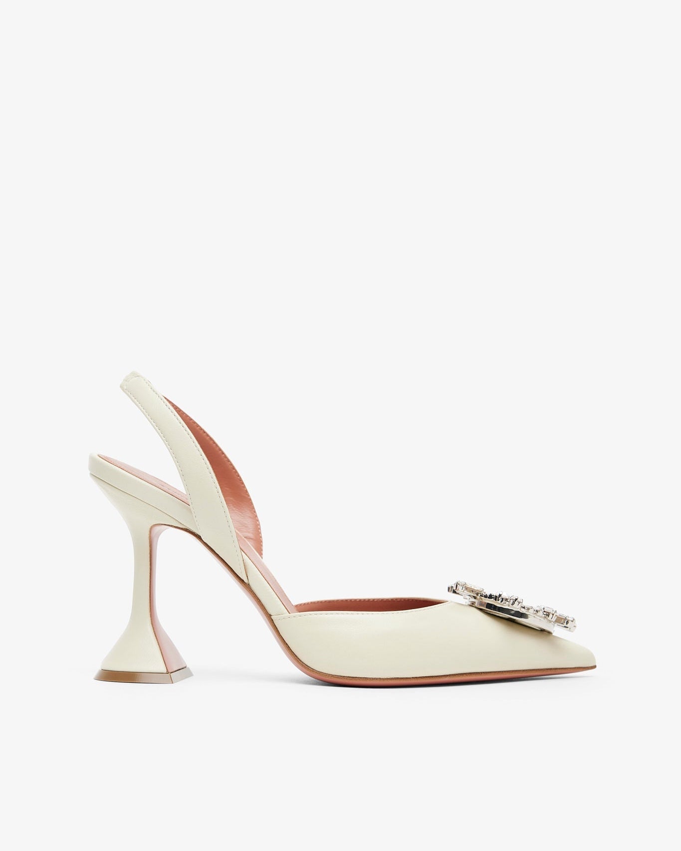 White high-heeled shoe with a decorative clasp on a white background