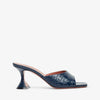 Navy blue high-heeled shoe with a subtle pattern on a white background