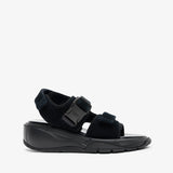 Black sandal with a thick sole on a white background