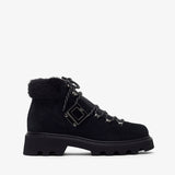 Black boot with fur trim on a white background