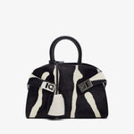 Black and white handbag with a distinctive pattern on a white background