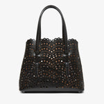 Black perforated handbag on a white background