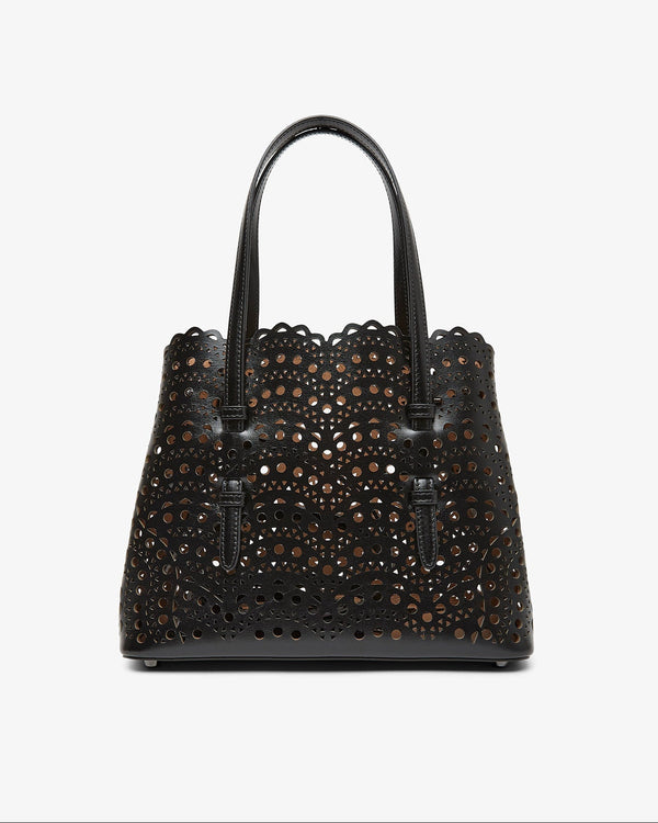 Black perforated handbag on a white background