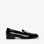 Brown studded flat shoe on a white background